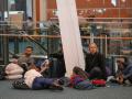 (221220) -- RICHMOND (CANADA), Dec. 20, 2022 -- People wait on the floor at Vancouver International Airport in Richmond