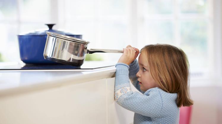 Young Girl Risking Accident With Pan In Kitchen model released Symbolfoto property released PUBLICAT