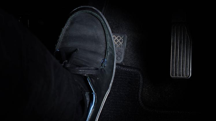 RECORD DATE NOT STATED Man foot and accelerator and brake pedal inside the car or vehicle and copy space which black col