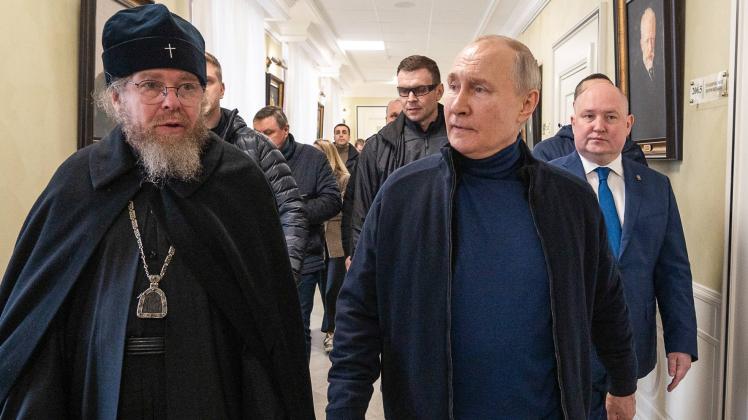 RUSSIA, SEVASTOPOL - MARCH 18, 2023: Russia s President Vladimir Putin (R) and Metropolitan Tikhon Shevkunov, chairman o