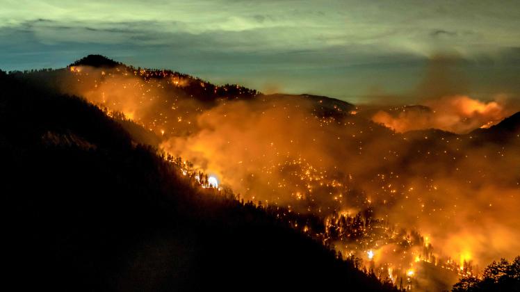 (FILES) In this file photo taken on September 18, 2020 The Bobcat Fire continues to burn through the Angeles National Forest in Los Angeles County, north of Azusa, California, September 17, 2020. - Earth is hotter than it has been in 125,000 years, but deadly heatwaves, storms and floods amplified by global warming could be but a foretaste as planet-heating fossil fuels put a "liveable" future at risk.o concludes the UN Intergovernmental Panel on Climate Change (IPCC), which has started a week-long meeting to distill six landmark reports totalling 10,000 pages prepared by more than 1,000 scientists over the last six years. (Photo by Kyle Grillot / AFP)