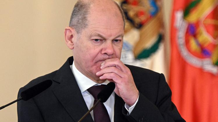German Chancellor Olaf Scholz listens as the Moldovan president addresses a joint press conference during a trilateral meeting with the Romanian president at the Cotroceni Palace, the Romanian Presidency headquarters, in Bucharest on April 3, 2023. (Photo by Daniel MIHAILESCU / AFP)