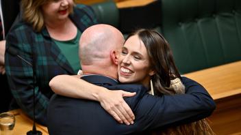JACINDA ARDERN VALEDICTORY ADDRESS, National leader Christopher Luxon hugs former Prime Minister Jacinda Ardern after he