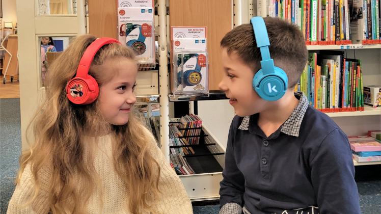Juna und Nolan Lehmann probieren das neue Hör-Angebot in der Uwe-Johnson Bibliothek in Güstrow aus.