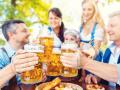 Group of friends toasting in beer garden, Group of friends toasting in Bavarian beer garden, Group of friends toasting i