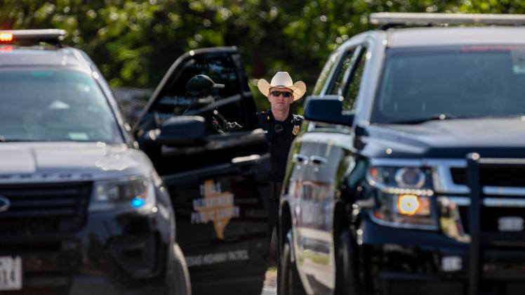 June 3, 2022, Uvalde, Texas, USA: A policer officer looks through the open doors of police vehicles during the funeral h