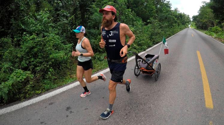 German athlete Jonas Deichmann (R) runs heading to the town of Santo Domingo in Cancun, Quintana Roo state, Mexico, 03 O