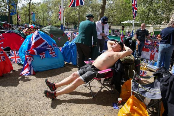 May 5, 2023, London, United Kingdom: A topless Royal supporter enjoys the sunshine along the Mall in central London on t