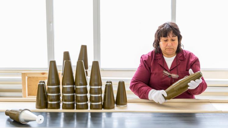 Worker at an assembly line in munition factory Sopot, Bulgaria - May 17, 2016: Female worker is checking explosive eleme