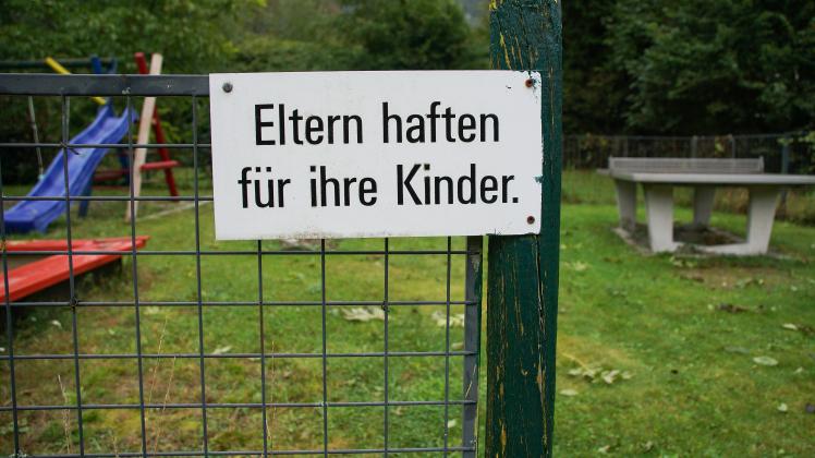 Bayern, Deutschland 21. September 2021: Am Zaun von einem Kinderspielplatz ist ein Schild angebracht, auf dem - Eltern h