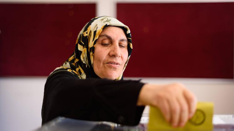 May 14, 2023, Istanbul, Turkey: A woman casts her vote in a ballot box at Saffet Ã‡ebi school polling station. 64 millio