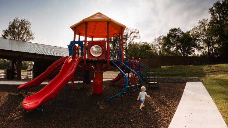 Child running toward playground at park Cape Girardeau, Missouri, United States CR_WEKW230117-1109593-01 ,model released