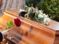 Mourning Woman at Funeral with coffin, Mourning woman on funeral with red rose standing at casket or coffin, Mourning wo