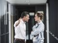 Businesswoman and businessman arguing in office passageway model released Symbolfoto property releas