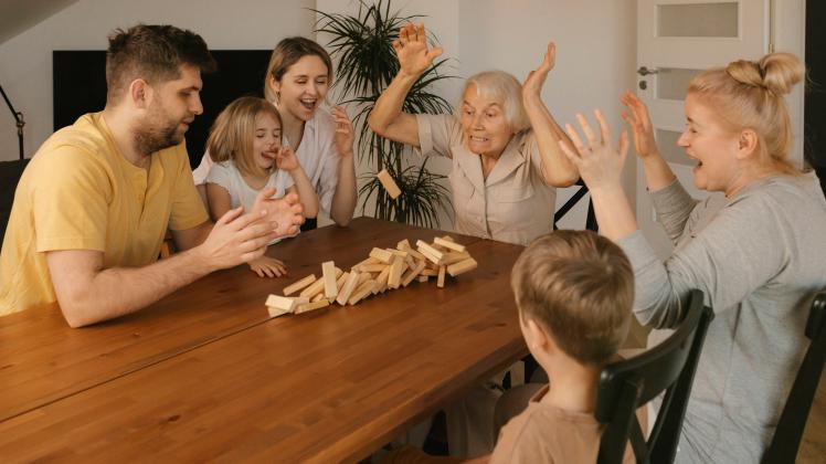 Multi-generation family playing leisure game on table at home model released, Symbolfoto property released, VIVF00629