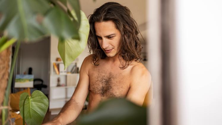 Smiling shirtless man with long hair at home model released, Symbolfoto property released, JCCMF10235