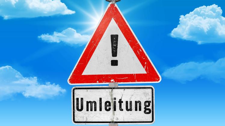 Augsburg, Bavaria, Germany - 27 June 2023: Warning sign in front of sky with the inscription: Detour. Warning of detour 