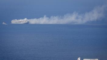 NORTH SEA - A cargo ship passes the Fremantle Highway on fire in the North Sea above Ameland. The fire on the cargo ship