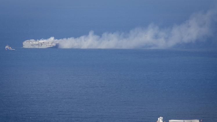 NORTH SEA - A cargo ship passes the Fremantle Highway on fire in the North Sea above Ameland. The fire on the cargo ship