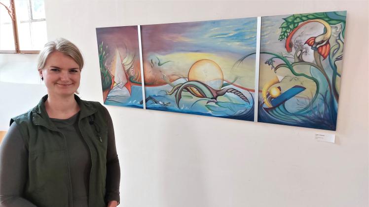 Künstlerin Nora Gauger neben ihrem Triptychon „Power“, dass sie extra für die Ausstellung in Krakow am See angefertigt hat.