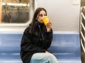 young woman drinking coffee in the subway New York, New York, United States R_NELA230610-1197045-01 ,model released, Sym