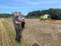 Landwirt Thomas Nölker ist erleichtert: Die Ernte in Pye scheint nicht so schlecht, wie erwartet. Gemeinsam mit seinen Söhnen Luke (auf dem Arm) und Tom beobachtet er den Mähdrescher.