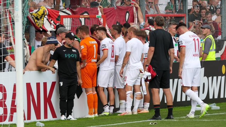 Fans (FC Augsburg) sichtlich sauer auf die Mannschaft und diskutieren mit den Spielern, SpVgg Unterhaching vs. FC Augsbu