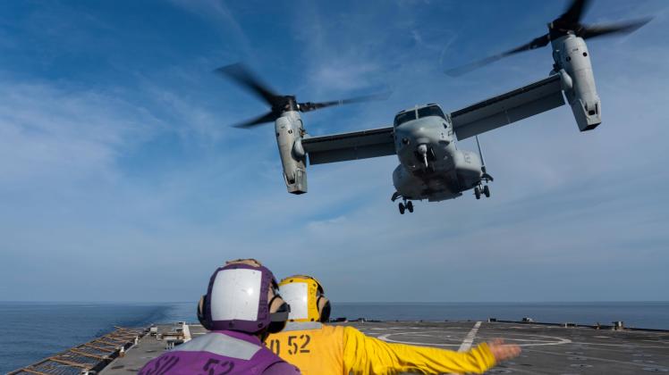 STYLELOCATIONU.S. Navy sailors guide a Marine Corps MV-22B Osprey aircraft, attached to Marine Medium Tiltrotor Squadron