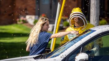 August 30, 2023, Burlington, ON, Canada: Beekeepers Terri Faloney, left, and Tyler Trute remove bees from a car after a 