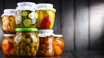 Jars with variety of marinated vegetables and fruits. Preserved food Jars with variety of marinated vegetables and fruit