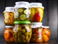 Jars with variety of marinated vegetables and fruits. Preserved food Jars with variety of marinated vegetables and fruit