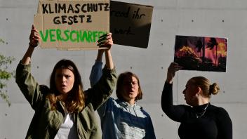 German climate activist Luisa Neubauer (L) of the Fridays for Future movement and other activists stage a demonstration for more climate protection outside parliament prior to a debate on the 2024 state budget at the Bundestag, the lower house of parliament, on September 6, 2023 in Berlin. (Photo by John MACDOUGALL / AFP)