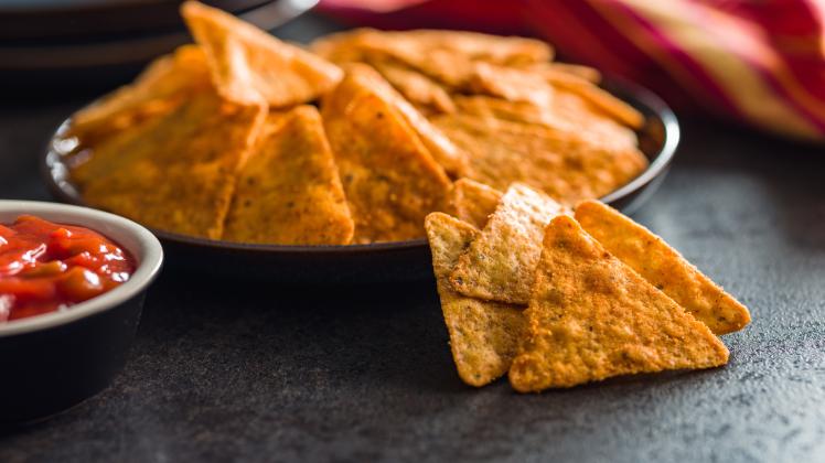 Tortilla chips with the flavor of chili peppers on plate., Tortilla chips with the flavor of chili peppers on the plate.