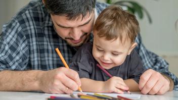 Father and son coloring together at home model released, Symbolfoto property released, ANAF01854