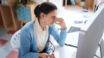 My brain might explode. a young businesswoman looking stressed while using a laptop at her desk in a modern office. My b