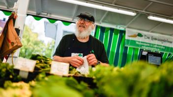 Pit Möller-Schlömann arbeitet beim Stand  von Gemüsegärtner. Aufgrund von Bauprojekten ist der Wochenmarkt am Ledenhof, der immer donnerstags stattfindet, seit Juli am Domhof zu finden. Foto: Michael Gründel