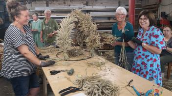 Landfrauen aus Risum-Lindholm arbeiten an einer Erntekrone.