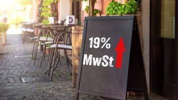 Bavaria, Germany - 15 August 2023: Increase in VAT in the catering industry from 2024 to 19% Symbol image. Board in fron