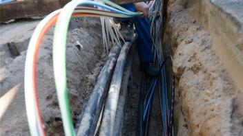 Baugrube mit Strom- und Glasfaserkabeln: Der schleswig-holsteinische Netzbetreiber SH Netz investiert westlich von Itzehoe mehr als eine Millionen Euro in die Infrastruktur.