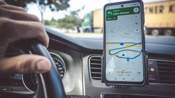 Bavaria, Germany - 3 October 2022: Google Maps navigation app in a car with a smartphone *** Google Maps Navigation App 