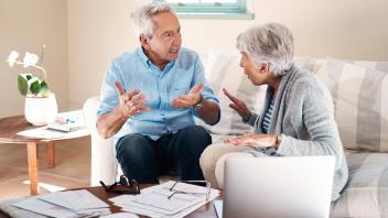Money can make a real mess of marriage. a senior couple having a disagreement while going through paperwork at home. Mon