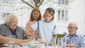 Boy cutting cake on dining table Bavaria Germany mit_2017_10159
