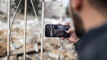 January 15, 2023, Jerusalem, Israel: A member of the Khader family filming the demolition of their house by the Jerusale