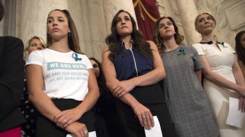 Aly Raisman L two time Olympian and victim of former Team USA Olympic doctor Larry Nassar stand