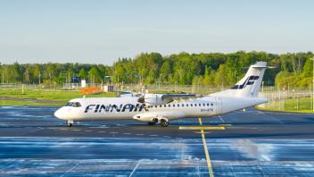 Finnair  small  commercial  aircraft  on  runway  at  the  airport  in  Tallinn,  Estonia.  Tallinn,