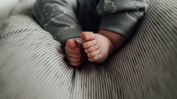 Close up of baby s feet and toes laying on gray neutral blanket United States, North Dakota, Bismarck R_KIFR231113-12868