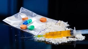 Close-up pile of powder and filled syringe with drugs. Close-up pile of powder and filled syringe with drugs. Drug addic