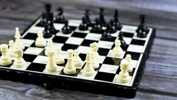 Chess, a board game for two players, called white and black, each controlling an army of chess piece