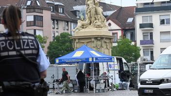 A police officer looks on as workers pack up the gear at the scene where several people were injured in a knife attack on May 31, 2024 in Mannheim, western Germany. Media reported that a prominent Islam critic was among those targeted. A man with a knife attacked and injured several people on the market square in Mannheim at around 11.35 am, police said in a statement. Police then shot at the attacker, who was also injured as a result. (Photo by Kirill KUDRYAVTSEV / AFP)