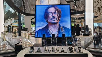 Economy And Bussiness In UAE A picture showing actor Johnny Depp promoting Dior aftershave Sauvage is seen at Abu Dhabi 